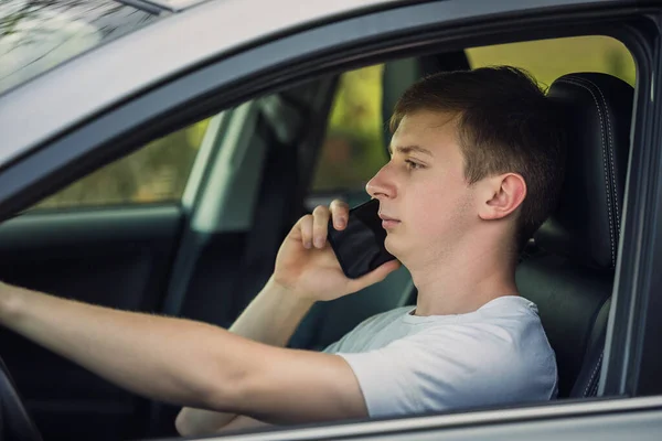 Jeune Homme Conduite Dangereuse Tandis Que Téléphone Parle Devant Volant Photos De Stock Libres De Droits