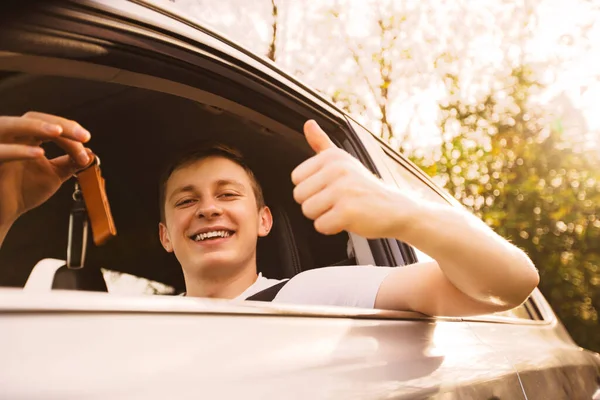 Novice Driver Holding Car Keys Out Window Showing Thumb Positive Stock Image