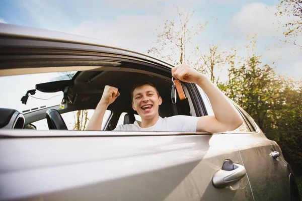 Happy Novice Driver Keeps Fist Tight Looking Out Driver Window Royalty Free Stock Images