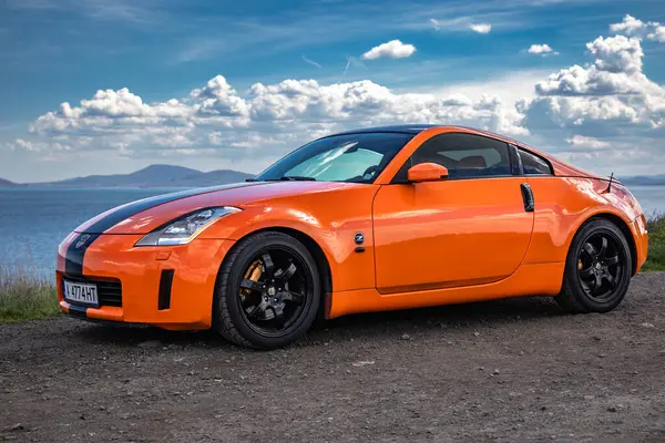 stock image Orange Nissan 350z (Nissan Fairlady Z (Z33) on the sea shore in Burgas, Bulgaria