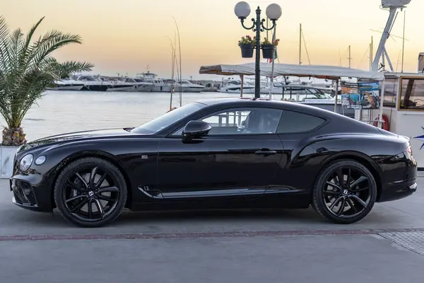 stock image Marina Dinevi, Sveti Vlas, Burgas, Bulgaria - August.17.2024, Black Bentley parked on yacht marina at sunset