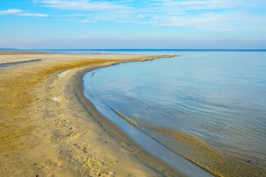 Natural background, sandy shore and water. Winter beach view