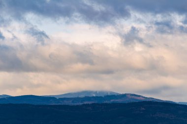 Forest mountain, hill under dramatic storm sky at sunset. Nature, weather background 