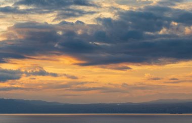 Deniz ve tepenin üstünde bulutlu gün batımı gökyüzü. Seyahat, doğa geçmişi, Hırvatistan, Krk Adası