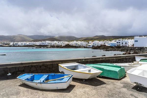 stock image Picturesque Punta Mujeres with white architecture and natural pools and boats in the foreground, Lanzarote, Canary Islands, Spain