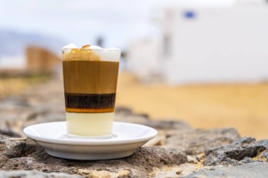 Delicious barraquito coffee with liquor and condensed milk, typical for Canary Island, La Graciosa, Spain clipart