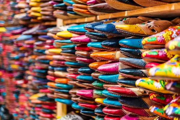 Colorful handmade leather slippers waiting for clients at shop in Fes, next to tanneries, Morocco, North Africa