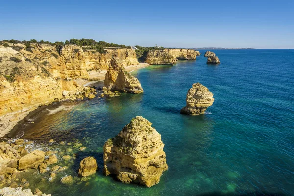 stock image Beautiful cliffs and rock formations by the Atlantic Ocean at Marinha Beach in Algarve, Portugal