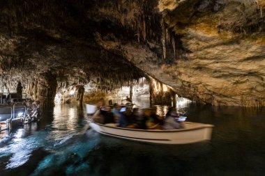 People in the boat on lake in amazing Drach Caves in Mallorca, Spain, Europe clipart