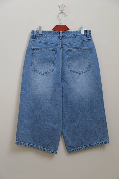 trendy denim pant hanging on wall hanger HD stock photos. 3 quarter printed denim pant back side stock photos.