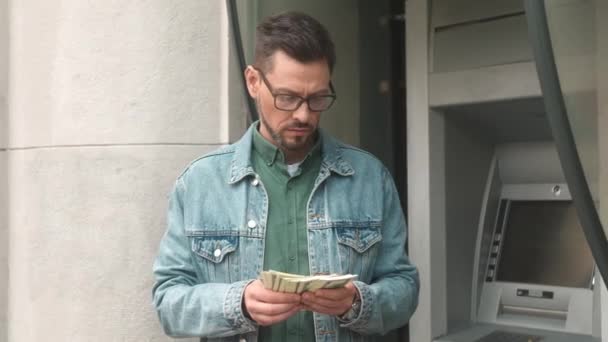 Portrait Young Successful Businessman Counting Dollar Bills Withdrawn Bank Card — Video