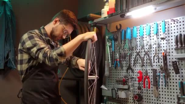 Skillful Handsome Focused Mechanic Fixing Bike Wheel Tools Standing Modern — ストック動画