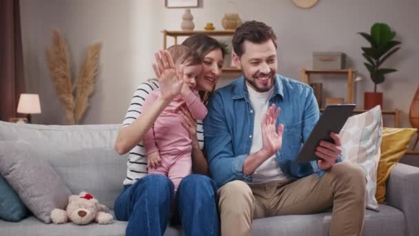 Jovem Família Sentada Sofá Tendo Videochamada Para Avós Pais Filhinha — Vídeo de Stock