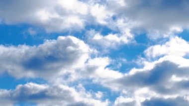 White clouds in the blue sky. Beautiful lush light clouds are quickly floating in a rich blue sky. Timelapse. Fast movement Time lapse. Colorful screensaver. Cinema scene. High quality film footage