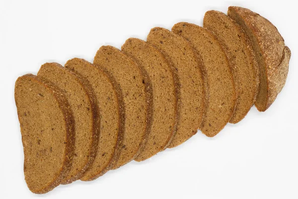 stock image Sliced black bread. Dark rye bread with cumin cut into even pieces on a white background. Wheat black bread on the table. Isolated. Bran from grain. Healthy food. Vegetarian food. Ecological friendly