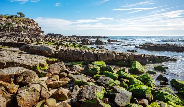 stock image Lookout and rocky headland at Point Arkwright, Coolum, Sunshine Coast, Queensland, on a sunny day with blue cloudy sky and blue water