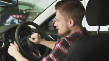 Büyüleyici bir dikiz aynası yakışıklı, sakallı bir adamı, galeride yeni şık arabasında otururken mutluluk saçan bir şekilde yakalıyor. Kendine güvenen gülüşü ve rahat duruşu yeni bir satın almanın verdiği heyecanı ve araba sürmenin heyecanını aktarıyor.