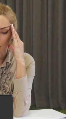 Şık bir bluz giymiş, çarpıcı, olgun, sarışın bir iş kadını, dizüstü bilgisayarına dalmış, gösterişli, modern bir ofiste konsantrasyonunu sergiliyor. Ortam profesyonellik ve yenilik yayıyor, kendisi strateji ve el işi yaparken.