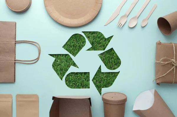 Collection of eco sustainable low carbon packaging with grass recycling symbol cutout in the centre