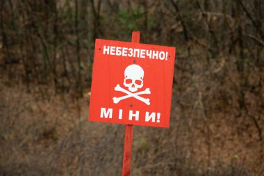 Danger sign in front of minefield - Ukraine, Donbass: Danger mines  Photo clipart