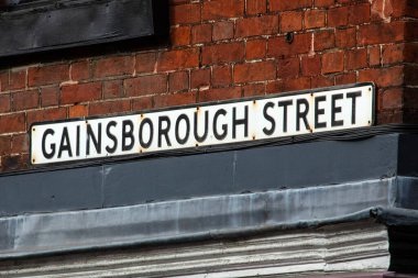 Close-up of the street sign for Gainsborough Street in the town of Sudbury in Suffolk, UK. clipart