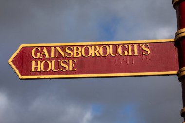A signpost for Gainsboroughs House in the pretty town of Sudbury in Suffolk, UK. clipart