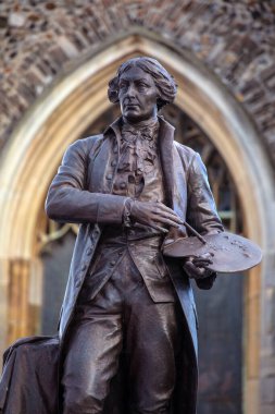 Suffolk, UK - October 28th 2023: Statue of famous English painter Thomas Gainsborough, in the historic town of Sudbury - where he was born and lived, in Suffolk, UK. clipart