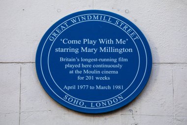London, UK - January 15th 2024: A blue plaque on Great Windmill Street in London, celebrating the film Come Play With Me - the longest running film in Britain. clipart