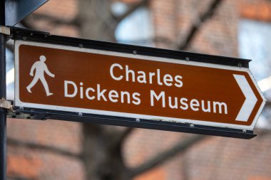 London, UK - February 5th 2024: A sign pointing visitors to the Charles Dickens Museum, located on Doughty Street in London, UK. clipart