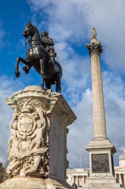 London, UK - February 19th 2024: Statue of King Charles I with Nelsons Column behind, at Trafalgar Square in London, UK. clipart