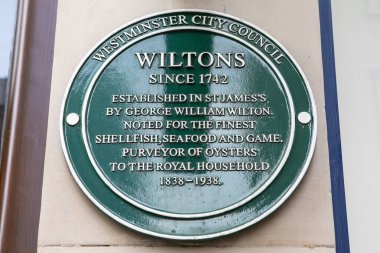 London, UK - February 19th 2024: A plaque located on Jermyn Street in London, UK, on the exterior of restaurant Wiltons - commemorating its history. clipart