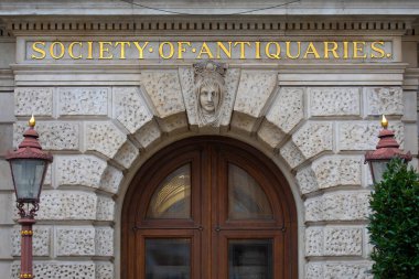 London, UK - February 26th 2024: The sign above the entrance to the Society of Antiquaries of London, located at Burlington House on Piccadilly in London, UK. clipart