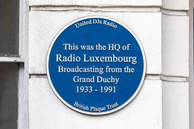 London, UK - February 26th 2024: A blue plaque on Hertford Street in Mayfair, London, marking where the headquarters of Radio Luxembourg was between 1933-1991. clipart