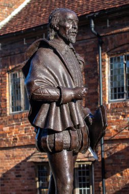 Stratford-Upon-Avon, UK - February 12th 2024: Statue of famous playwright William Shakespeare in Stratford-Upon-Avon - his birthplace in Warwickshire, UK. clipart