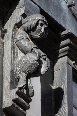 A beautiful wooden carving of a Faun, on an old timber-framed building in the town of Stratford-Upon-Avon, UK.  The town is the birthplace of William Shakespeare. clipart