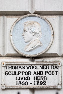 A sculptured plaque on Welbeck Street in London, marking where famous sculptor and poet Thomas Woolner lived in the 1800s. clipart
