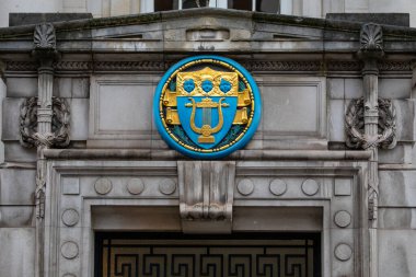 London, UK - March 18th 2024: The symbol on the exterior of the School of Philosophy and Economic Science, located on Mandeville Place in London, UK. clipart