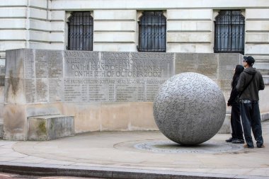 London, UK - March 18th 2024: Tourists looking at the poignant Bali Bombings Memorial at Clive Steps in London, UK. clipart