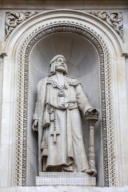 London, UK - April 3rd 2024: Statue of Sir Richard Whittington - the inspiration of the folk tale Dick Whittington and His Cat, on the Royal Exchange building in London, UK. clipart