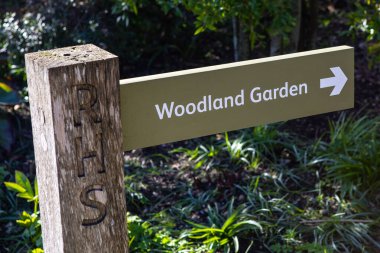 Essex, UK - April 2nd 2023: Signpost for the Woodland Garden at RHS Hyde Hall in Essex, UK. clipart