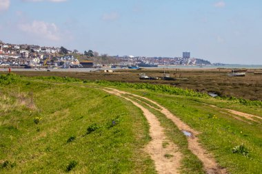 The view across the Salt Marsh towards Leigh-on-Sea in Essex, UK.  Southend-on-Sea Pier can also be seen in the distance. clipart