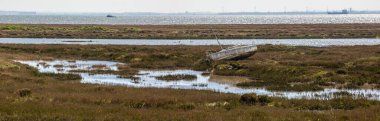 A panoramic view overlooking the Salt Marsh at Leigh-on-Sea in Essex, UK.  The body of water in the background is the Thames Estuary. clipart