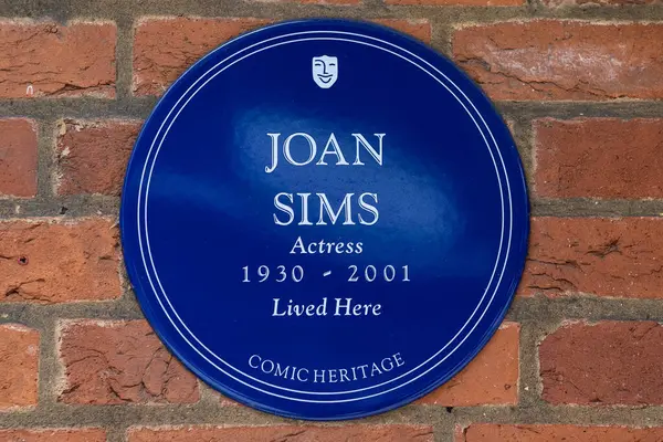 stock image London, UK - March 30th 2023: A blue plaque located on Thackeray Street in London, UK, marking the location where actress Joan Sims used to live.
