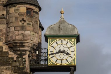 Close-up of the clock on the facade of Canongate Tolbooth in Edinburgh, Scotland. clipart