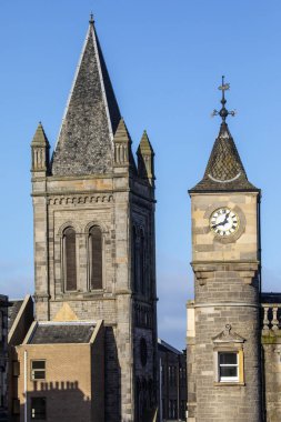 Old church tower, now part of a residential building, pictured with a clock tower, originally part of the Edinburgh Savings Bank building, in Stockbridge, Edinburgh. clipart