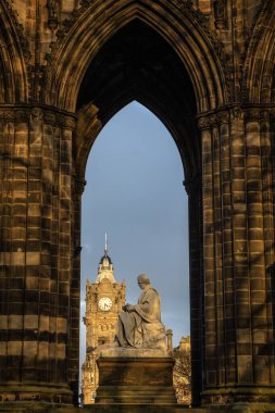 Edinburgh, İskoçya - 14 Şubat 2023: Edinburgh, İskoçya 'daki Scott Anıtı kemeri. İskoç yazar Sir Walter Scott 'ın heykeli ve Balmoral Oteli kulesi görünür..