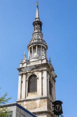 The magnificent spire of St. Mary-le-Bow church, topped with a gold Dragon sculpture, in the City of London, UK. clipart