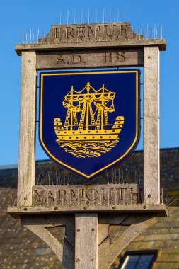 A sign portraying the town crest of Yarmouth, on the beautiful Isle of Wight, UK.  The tower of St. James Church is also pictured. clipart
