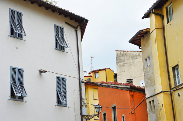 Terracotta house on the corner streets of Sapiti and Sprone near square Passera in Florence, Italy