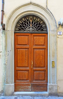 The front door of a house at 2 Presto di S.Martino Street in Florence, Italy